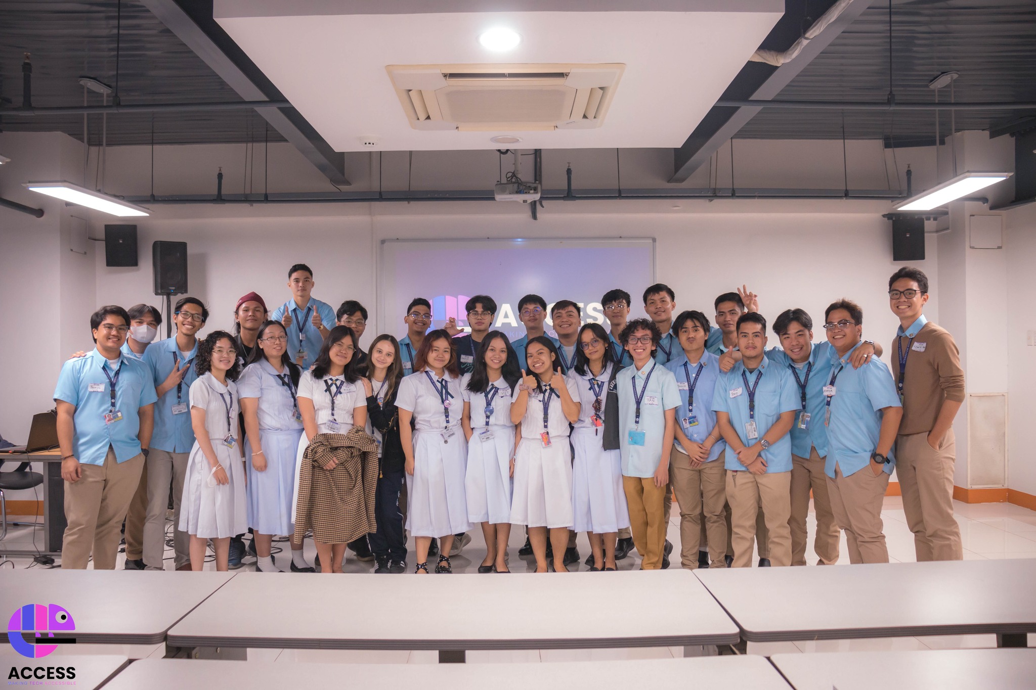 ACCESS officers and members in uniform at a formal event with the ACCESS logo projected behind them
